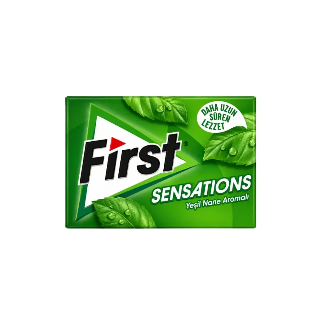 A rectangular green package of First Sensations gum with a white and green design, featuring the brand name 'First' in bold black letters and illustrations of mint leaves with water droplets.